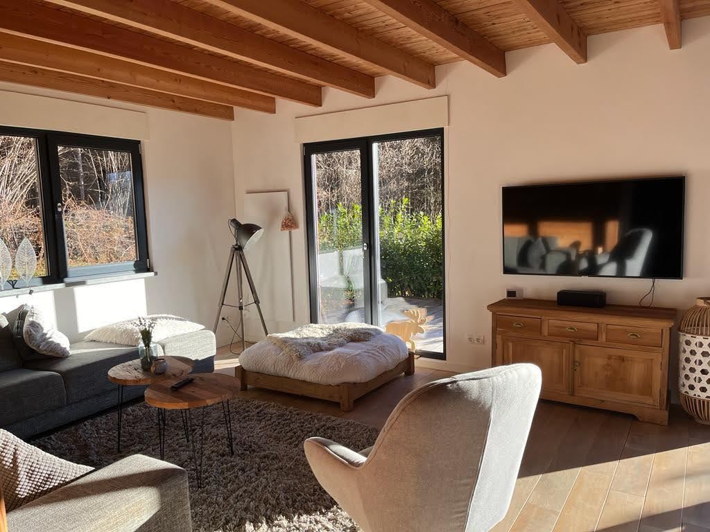 Chalet Presseggersee comfortable living room with corner sofa, dining table for 10, smart TV and wood stove