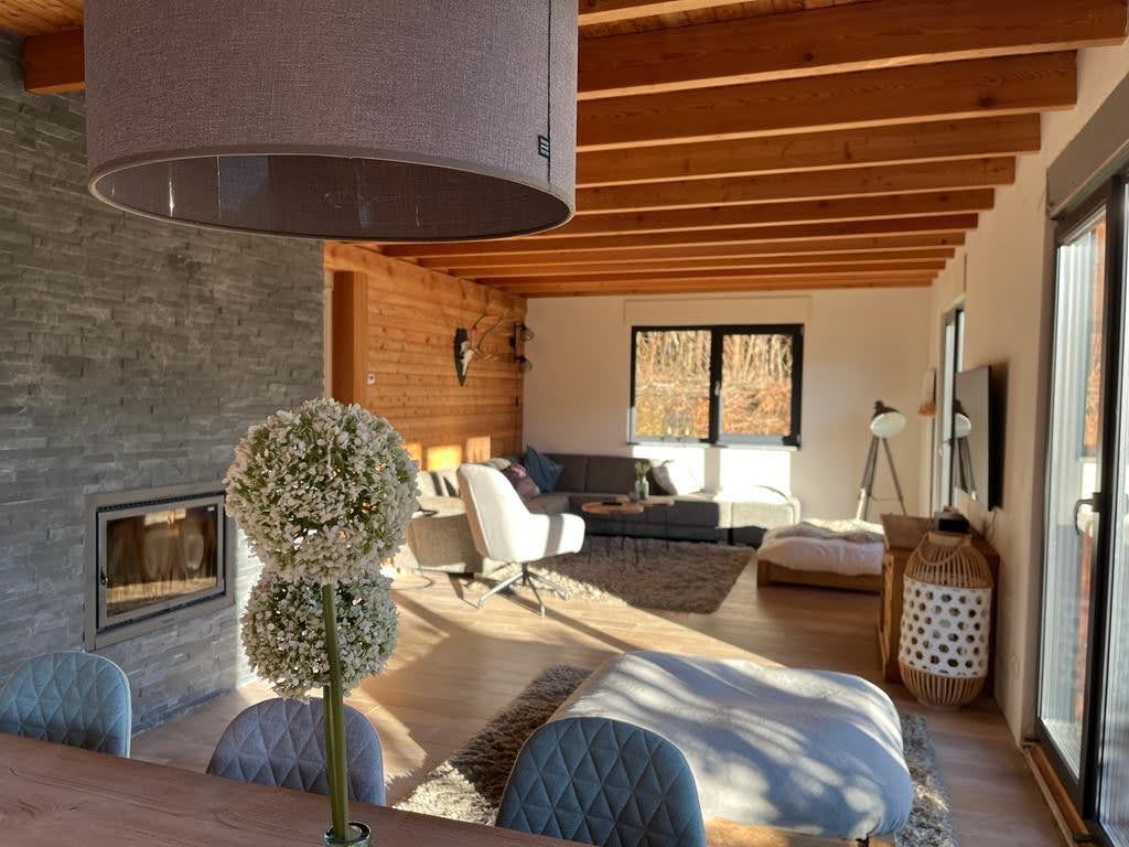 Chalet Presseggersee comfortable living room with corner sofa, dining table for 10, smart TV and wood stove